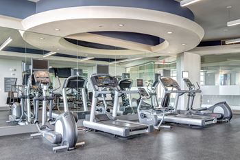 24-Hour fitness center with cardio & free weight equipment